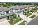 Eye-level view of this two-story home with a large driveway, front lawn, and mature landscaping at 16082 Sonoma Grove Cir, Tampa, FL 33647