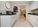 Well-lit kitchen with white cabinetry, black countertops, and stainless steel toaster oven at 1609 Bunker Hill Dr, Sun City Center, FL 33573