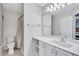 Bathroom featuring a single vanity, a mirror, commode, and a shower at 19029 Us Highway 19 N # 1-22, Clearwater, FL 33764