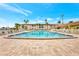 Community pool with paved sundeck surrounded by tropical landscaping and lounge chairs at 19029 Us Highway 19 N # 1-22, Clearwater, FL 33764