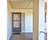 View of the front door to this residence with a decorative welcome mat and neutral facade at 19029 Us Highway 19 N # 1-22, Clearwater, FL 33764