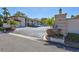 Inviting exterior showcasing a beige building, a parking area, and well-maintained landscaping with palm trees at 19029 Us Highway 19 N # 1-22, Clearwater, FL 33764