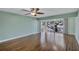 Large living room with lovely wood floors, fan, and natural light from the balcony doors at 19029 Us Highway 19 N # 1-22, Clearwater, FL 33764