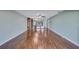Expansive living area with hardwood floors, built-in shelving, and a mirrored wall at 19029 Us Highway 19 N # 1-22, Clearwater, FL 33764