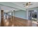 Open-concept living space featuring hardwood floors, mirrored wall, and sliding glass doors at 19029 Us Highway 19 N # 1-22, Clearwater, FL 33764