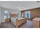 Main bedroom with neutral carpet, a ceiling fan, and natural light from two windows at 19029 Us Highway 19 N # 1-22, Clearwater, FL 33764