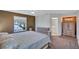 Main bedroom featuring a ceiling fan, a bed, and a view of the main bathroom at 19029 Us Highway 19 N # 1-22, Clearwater, FL 33764