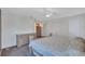 Main bedroom featuring a ceiling fan, a bed, and a dresser at 19029 Us Highway 19 N # 1-22, Clearwater, FL 33764