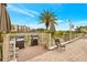 Outdoor grill area with two grills, seating, and a water view for community residents at 19029 Us Highway 19 N # 1-22, Clearwater, FL 33764