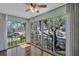Bright sunroom with hardwood floors and large windows showcasing the outdoor view at 19029 Us Highway 19 N # 1-22, Clearwater, FL 33764