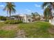 Expansive backyard with well maintained lawn, screened in porch and mature trees at 1936 Arrowhead Ne Dr, St Petersburg, FL 33703