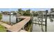 A wooden dock over a canal with boat lifts and easy access to the open water at 1936 Arrowhead Ne Dr, St Petersburg, FL 33703