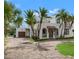 Mediterranean-style home with a brown brick driveway, mature trees, and manicured front yard at 1936 Arrowhead Ne Dr, St Petersburg, FL 33703