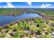 Stunning aerial view of a lakeside property featuring a home nestled among lush trees and tranquil waters at 19531 Deer Lake Rd, Lutz, FL 33548