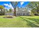 Expansive backyard with ample green space and a view of the house at 19531 Deer Lake Rd, Lutz, FL 33548