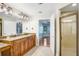Bathroom with granite countertop vanity, shower, and view into the main bedroom at 19531 Deer Lake Rd, Lutz, FL 33548