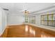Spacious bedroom featuring hardwood floors, a ceiling fan, and windows with shutter-style blinds at 19531 Deer Lake Rd, Lutz, FL 33548