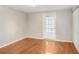 Cozy bedroom with hardwood floors, closet, and French door to outdoor patio at 19531 Deer Lake Rd, Lutz, FL 33548