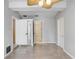 Bedroom with multiple closets, tile floors and a ceiling fan with tropical leaves at 19531 Deer Lake Rd, Lutz, FL 33548