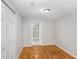 Bedroom features hardwood floors, closet, and door with window leading outside at 19531 Deer Lake Rd, Lutz, FL 33548