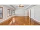 Bright bedroom showcasing hardwood floors, large windows with blinds, and ample space at 19531 Deer Lake Rd, Lutz, FL 33548