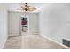 Bright bedroom with tile floors and a ceiling fan with tropical leaves at 19531 Deer Lake Rd, Lutz, FL 33548