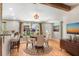 Bright dining room features hardwood floors, round table, and large window views at 19531 Deer Lake Rd, Lutz, FL 33548