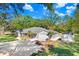 Inviting single-story home featuring lush landscaping, a spacious driveway, and a storage shed in the backyard at 19531 Deer Lake Rd, Lutz, FL 33548