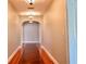 Hallway featuring hardwood floors, recessed lighting, and archways leading to other rooms in the home at 19531 Deer Lake Rd, Lutz, FL 33548