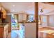 Kitchen featuring light wood cabinets, tile floors, granite counters, and a window with natural light at 19531 Deer Lake Rd, Lutz, FL 33548