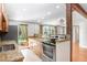 Well-lit kitchen features stainless steel oven, granite countertops, and wood cabinetry at 19531 Deer Lake Rd, Lutz, FL 33548