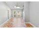 Bright and airy living area featuring tiled flooring, a ceiling fan, a skylight, and glass doors leading to the outdoors at 19531 Deer Lake Rd, Lutz, FL 33548