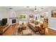 Cozy living room with hardwood floors, a fireplace, and comfortable furniture on a decorative area rug at 19531 Deer Lake Rd, Lutz, FL 33548