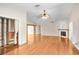 Open-concept living space with hardwood floors, a fireplace, and built-in storage, providing ample room for living at 19531 Deer Lake Rd, Lutz, FL 33548