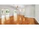 Expansive living room featuring hardwood floors, multiple archways, and a ceiling fan creating an inviting atmosphere at 19531 Deer Lake Rd, Lutz, FL 33548