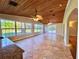 Open concept living room with wood ceilings, tile floors, and lots of natural light at 19531 Deer Lake Rd, Lutz, FL 33548