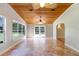 Bright, airy sunroom with a wood paneled ceiling, tile floors and large windows overlooking the backyard at 19531 Deer Lake Rd, Lutz, FL 33548