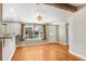 Bright living area with hardwood floors, a large window, and access to the home's exterior at 19531 Deer Lake Rd, Lutz, FL 33548