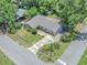 An aerial view of the home showcasing landscaping, roof, and surrounding trees at 2412 Giddens Ave, Seffner, FL 33584