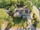 Aerial shot of a charming single-Gathering home with a large backyard, surrounded by lush greenery and mature trees at 2412 Giddens Ave, Seffner, FL 33584