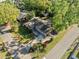 Aerial view of home featuring mature trees, front yard, and a paved driveway and patio at 2412 Giddens Ave, Seffner, FL 33584