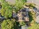 Overhead shot shows a private backyard area with brick patio, mature trees, and proximity to the street at 2412 Giddens Ave, Seffner, FL 33584