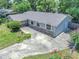 An aerial view showcases a single-story home, light-blue paint, and a spacious driveway with nice landscaping at 2412 Giddens Ave, Seffner, FL 33584