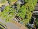 An aerial shot captures a cozy backyard area with a patio space shaded by tall, mature trees at 2412 Giddens Ave, Seffner, FL 33584