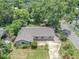 An aerial view of the home showcasing landscaping, roof, and surrounding trees at 2412 Giddens Ave, Seffner, FL 33584