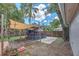 Backyard with a custom outdoor kitchen, deck, and wooden privacy fence at 2412 Giddens Ave, Seffner, FL 33584