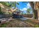 Backyard features a covered outdoor kitchen or bar area, mature trees, and partial shade at 2412 Giddens Ave, Seffner, FL 33584