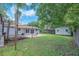 View of backyard with patio, shed, lawn, and partial view of the home's rear exterior at 2412 Giddens Ave, Seffner, FL 33584