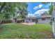 Spacious backyard with a brick patio, a lush lawn, and mature trees at 2412 Giddens Ave, Seffner, FL 33584