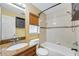 Bathroom featuring a granite countertop vanity and shower over tub with decorative tiled walls at 2412 Giddens Ave, Seffner, FL 33584